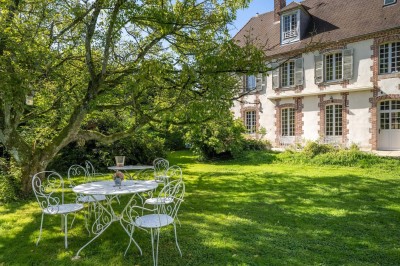 Miniature Location salle Villotran (Oise) - Au Vieux Château #9 Pelouse verdoyante entourée d'arbres sous un ciel dégagé, avec des pierres anciennes visibles au premier plan.