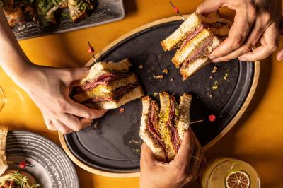 Assortiment de viennoiseries et fruits frais disposés sur un comptoir en métal dans un espace lumineux.