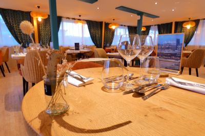 Garage avec sol en béton, mur en parpaings, éclairage au néon, et sortie donnant sur une allée extérieure.