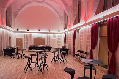 Chambre moderne avec lit double, décor sombre, mur orné d'une grande photo artistique et éclairage tamisé.