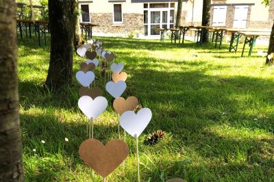Dortoir avec plusieurs lits superposés en bois, matelas et oreillers, sur un sol carrelé clair.