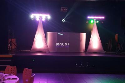 Personnes dansant dans une ambiance de fête avec des lumières colorées et des faisceaux laser.