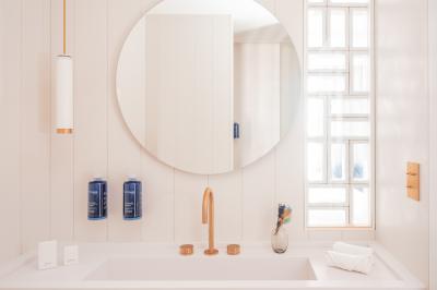 Table dressée pour deux avec vue sur un port de plaisance, des voiliers et la mer sous un ciel dégagé.