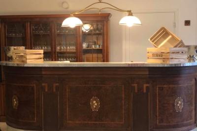 Salle de bain moderne avec douche à paroi vitrée, lavabo rond sur meuble en bois et miroir encadré en rotin.