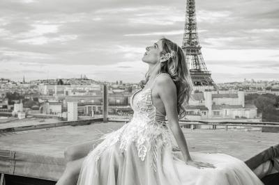 Un couple en tenue de mariage pose dans une forêt verdoyante, éclairée par une lumière douce.