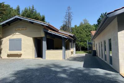 Décoration de table de réception avec nappes blanches, chandeliers, vaisselle élégante et arrangement floral blanc.