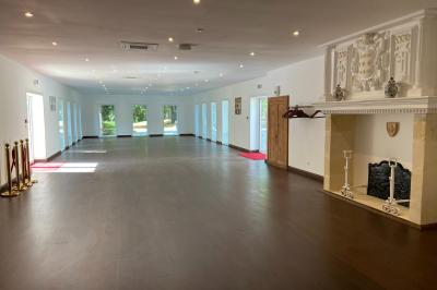 Décoration de table de réception avec nappes blanches, chandeliers, vaisselle élégante et arrangement floral blanc.