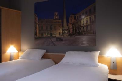 Espace lounge avec fauteuils modernes, tables basses en bois et mur décoré d'une image d'échiquier.