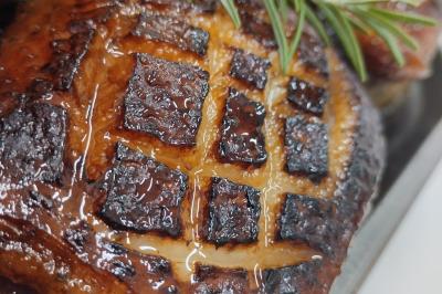 Plateau en bois avec verrines garnies, bol de pain tranché et bouteille de vin mousseux en arrière-plan.