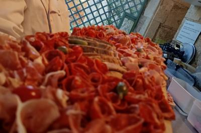 Plateau en bois avec verrines garnies, bol de pain tranché et bouteille de vin mousseux en arrière-plan.