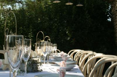 Salon lumineux avec canapé turquoise, coussins colorés, télévision, tapis en fibres naturelles et vue sur une cuisine…