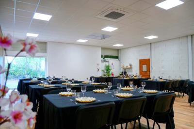 Miniature Location salle Jonchery-sur-Vesle (Marne) - Le Clic'zen #3 Salon lumineux avec canapé en cuir, poufs noirs, fauteuils en bois, table basse et mur décoratif coloré.