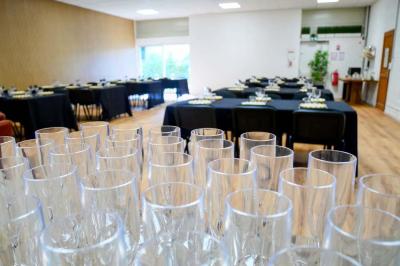 Miniature Location salle Jonchery-sur-Vesle (Marne) - Le Clic'zen #4 Salon lumineux avec canapé en cuir, poufs noirs, fauteuils en bois, table basse et mur décoratif coloré.