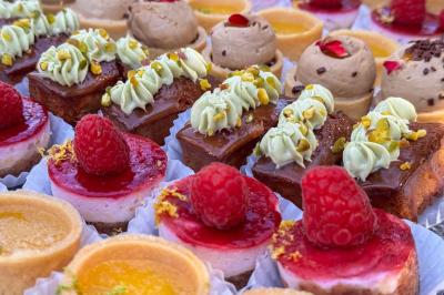 Mur en pierre orné d'une mosaïque colorée représentant un motif circulaire, entouré de végétation.