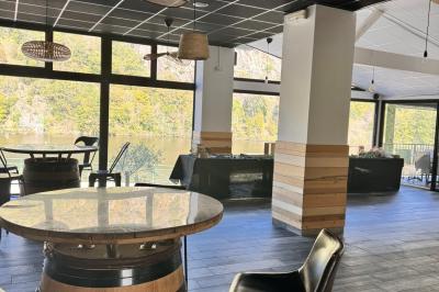 Un kayakiste pagaye sur une rivière calme entourée de végétation et de falaises verdoyantes.