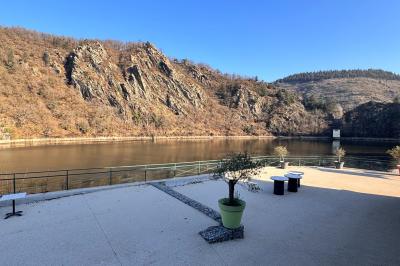 Miniature Location salle Caloire (Loire) - Domaine du Moulin #12 Salle de réunion avec tables en bois disposées en U, chaises, carafes d'eau et verres, éclairée par des lumières extérieures.