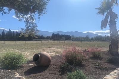 Miniature Location salle Saint-Génis-des-Fontaines (Pyrénées-Orientales) - Mas Puig #24 Vue aérienne d'une maison en pierre avec piscine, jardin, terrasse et espaces verts environnants.