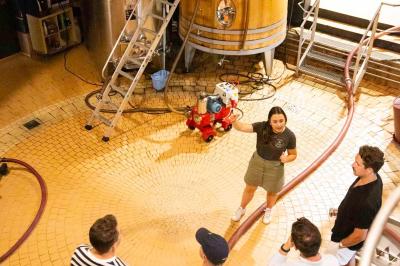 Baignoire blanche avec robinetterie moderne, serviette accrochée et produits de soin posés sur le rebord.
