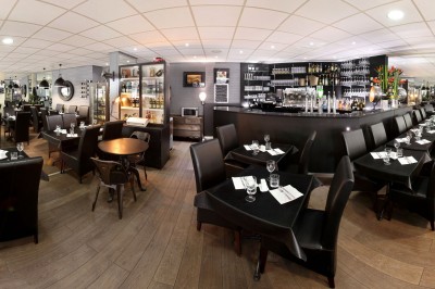 Assiette de dessert composée de meringues, éclats de caramel, feuilles de menthe et miettes de biscuit noir.