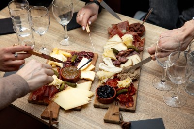 Miniature Traiteur Paris 9 (Paris) - Le 17.45 Paris #10 Fondue au fromage dans un caquelon rouge, avec du pain trempé sur des fourchettes, accompagnée de vin et de cornichons.