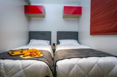 Vue aérienne d'un complexe avec piscines, bâtiments, espaces verts et parkings, entouré de végétation.