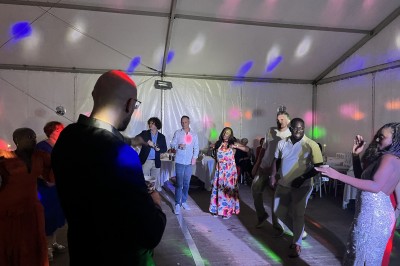 Miniature DJ Argentré-du-Plessis (Ille-et-Vilaine) - Kondo Event's #13 Des personnes dansent sous une tente éclairée par des lumières colorées, avec une table de mixage au premier plan.