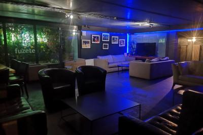 Deux micros sur scène dans une salle sombre, avec un écran lumineux affichant du texte en arrière-plan.