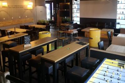 Deux micros sur pied dans une salle sombre, éclairée par un écran lumineux affichant un texte flou.