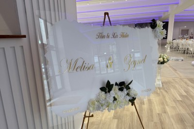 Parking vide avec marquages au sol, entouré de bâtiments résidentiels et d'arbres sous un ciel nuageux.