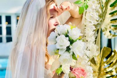 Chambre lumineuse avec jacuzzi intégré, lit double, murs en pierre blanche et décoration élégante.