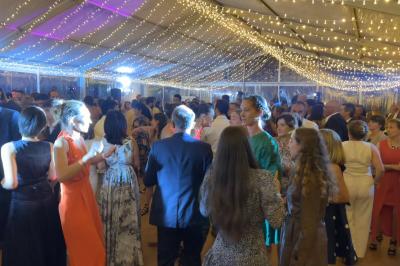 Deux faisceaux lumineux blancs traversent une salle avec des murs en pierre, éclairant un espace légèrement enfumé.