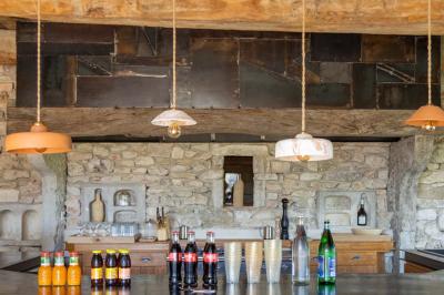 Arbuste à feuillage dense à gauche et arbre taillé à droite dans un jardin verdoyant sous un ciel clair.