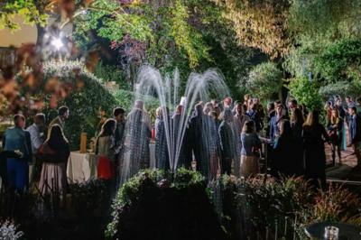 Vue aérienne d'une zone rurale avec des arbres, un cours d'eau sinueux et des bâtiments aux toits rouges.