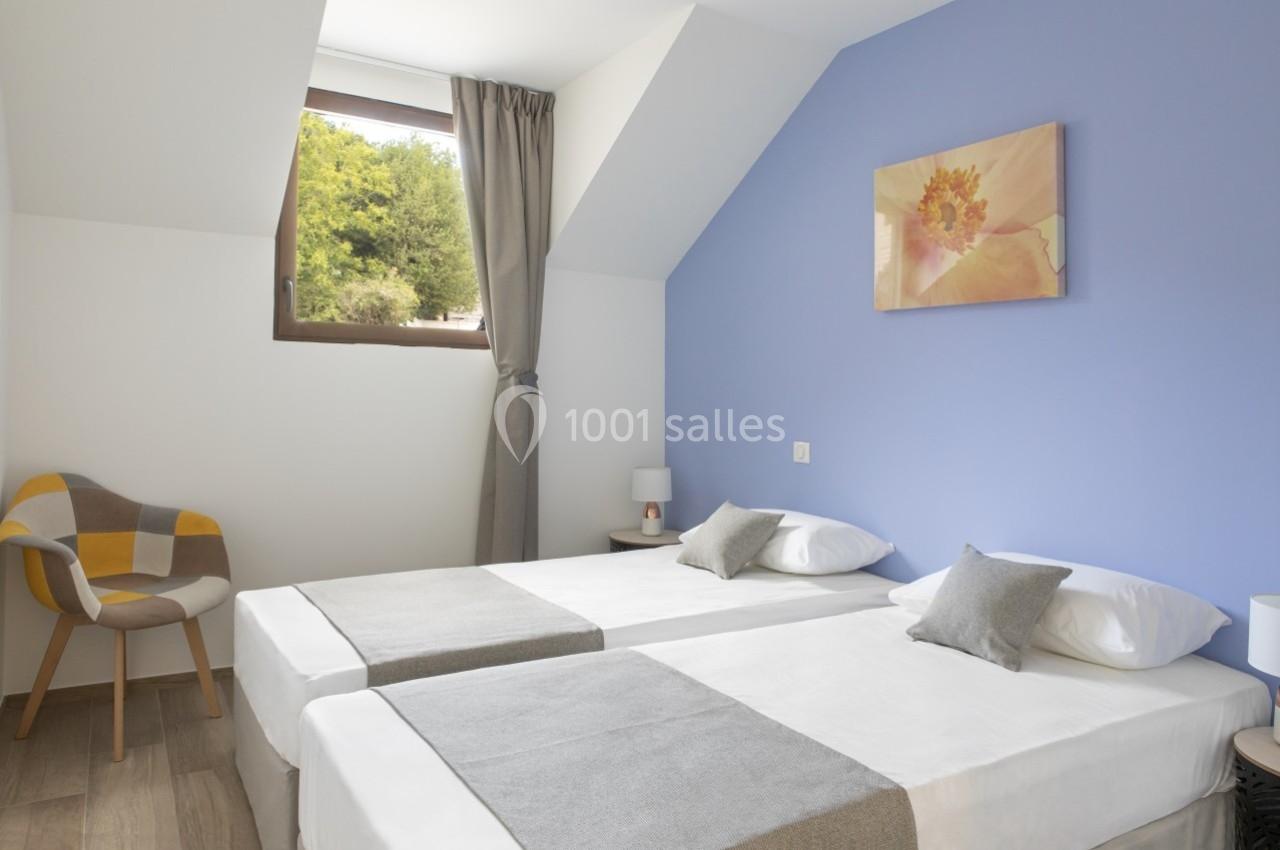 Location salle Saint-Samson-de-la-Roque (Eure) - Manoir Néo Normand #33 Deux lits simples avec draps blancs et couvre-lits gris dans une chambre lumineuse aux murs bleus et blancs.