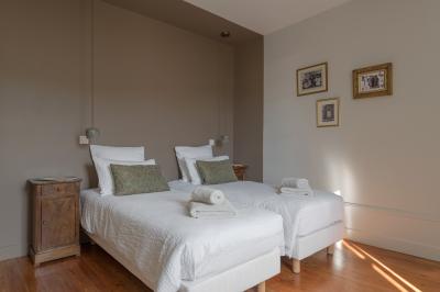 Table dressée en extérieur avec boissons fraîches, carafes d'eau infusée, bouteilles et verres sur une nappe blanche.