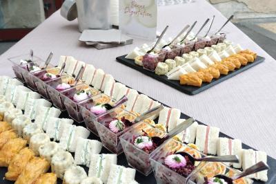 Table dressée avec des verres et un seau à champagne devant une baie vitrée, logo ’Aux Saveurs du Jour’ au mur.