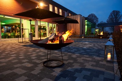 Lavabo moderne avec robinet chromé, serviettes blanches pliées et produits de toilette sur un plan en bois.
