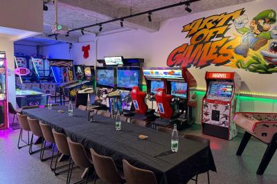 Cuisine extérieure moderne avec comptoir en bois, abri noir et lumière naturelle filtrée par le soleil.