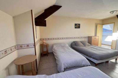 Salle de bain avec lavabo, miroir, meuble blanc et douche à paroi vitrée sur un carrelage beige.