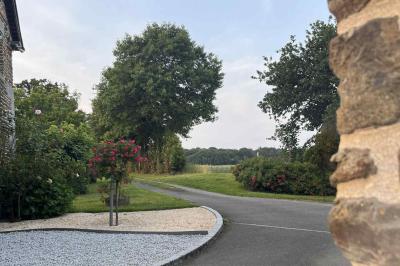 Salle de bain avec lavabo, miroir, meuble blanc et douche à paroi vitrée sur un carrelage beige.