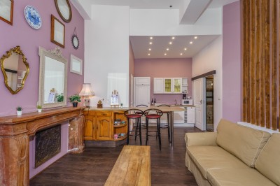 Buffet avec pâtisseries, viennoiseries, verrines et pains disposés sur des présentoirs en bois dans une salle.