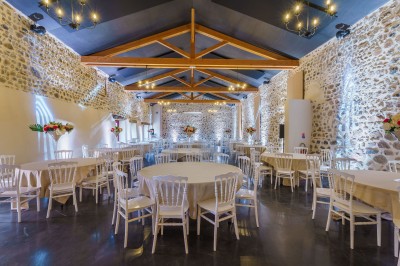 Buffet avec pâtisseries, viennoiseries, verrines et pains disposés sur des présentoirs en bois dans une salle.