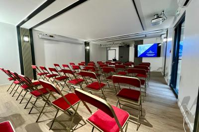 Entrée d'un immeuble avec porte vitrée, numéro 16 et inscription ’Bureaux’, sol pavé avec quelques feuilles.