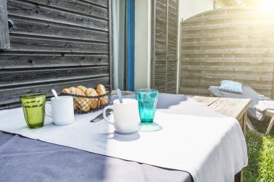 Deux chaises longues colorées devant une décoration murale représentant une plage avec un palmier.
