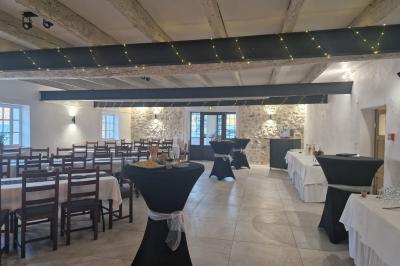 Cuisine professionnelle équipée avec plans de travail en inox, cuisinières, hotte et four à micro-ondes.