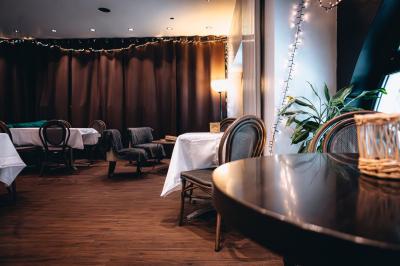 Bouteilles de bière variées alignées sur une étagère en bois devant un mur en pierre.