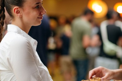 Plusieurs Citroën 2CV colorées alignées sur un parking ensoleillé.