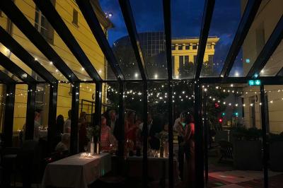 Table dressée avec des verres, des bouteilles décoratives, des citrons et un panneau indiquant un bar à spritz.