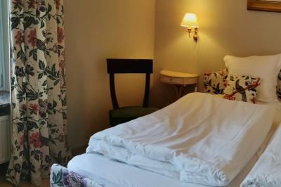 Un couple en tenue de mariage se tient devant un officiant dans un décor festif avec sapins et guirlandes lumineuses.