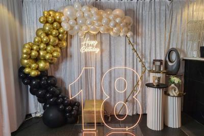 Figurines de mariés sur un gâteau décoré de fleurs bleues, d'une feuille argentée et d'un cœur en arrière-plan.